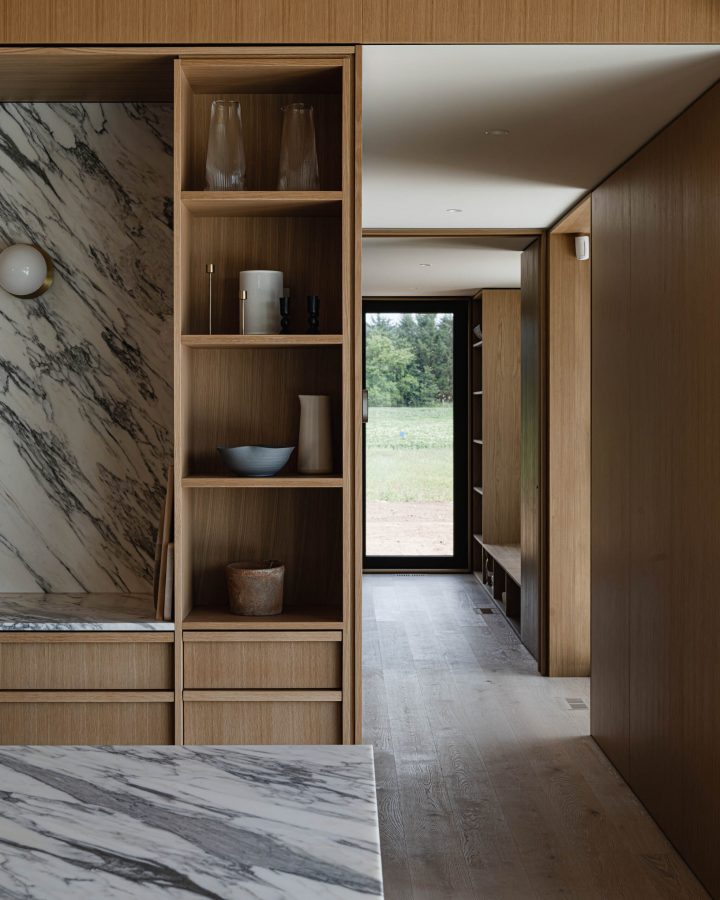 Millwork detail in a modern barn house kitchen featuring custom walnut millwork, paneling and architectural reveals