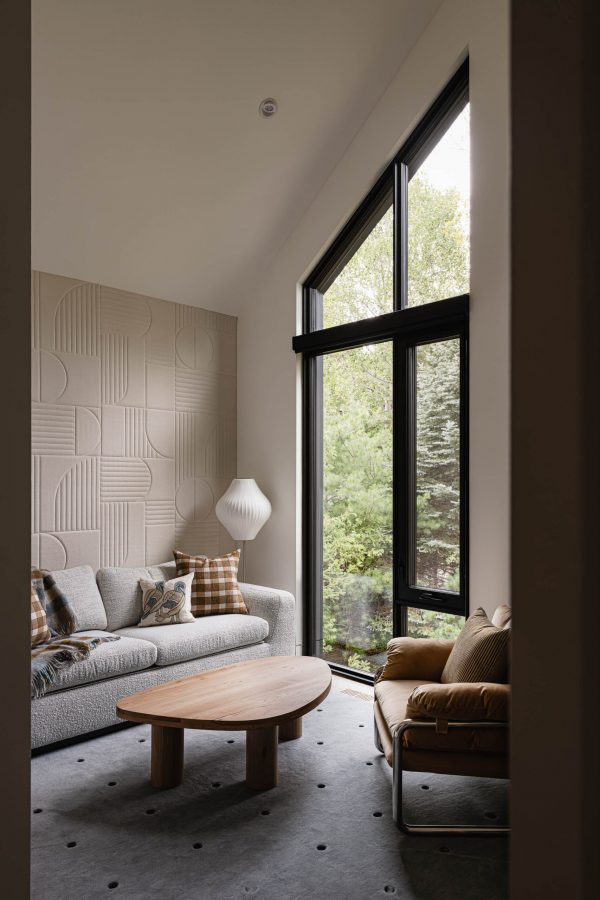 Contemporary office in a modern alpine chalet with vaulted ceiling, peaked windows, and textured geometric patterned wall covering