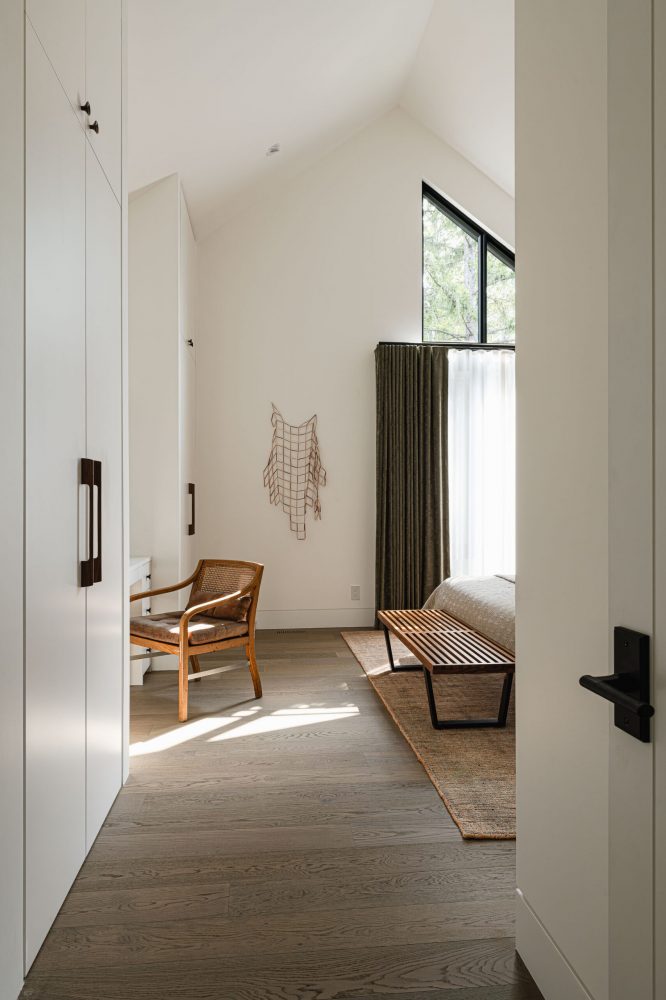 Custom millwork amd entry leading into the primary bedroom of a modern alpine chalet