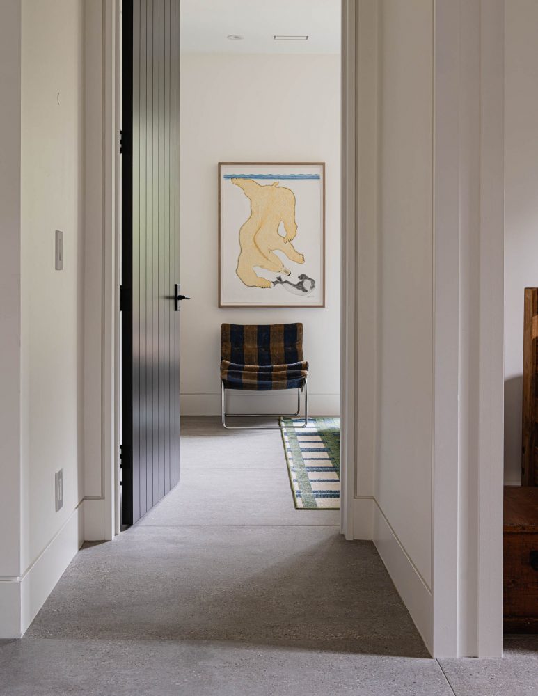Architectural detail of a modern chalet featuring large format concrete tile floors, baseboard reveals, and contemporary finishes